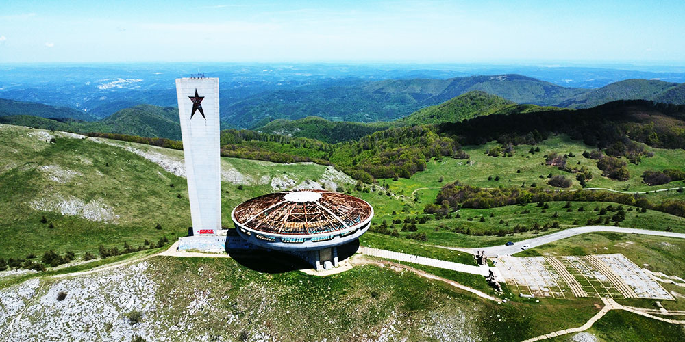 The abandoned Buzludzha Monument, a large concrete saucer-shaped building, on a Balkan mountain peak